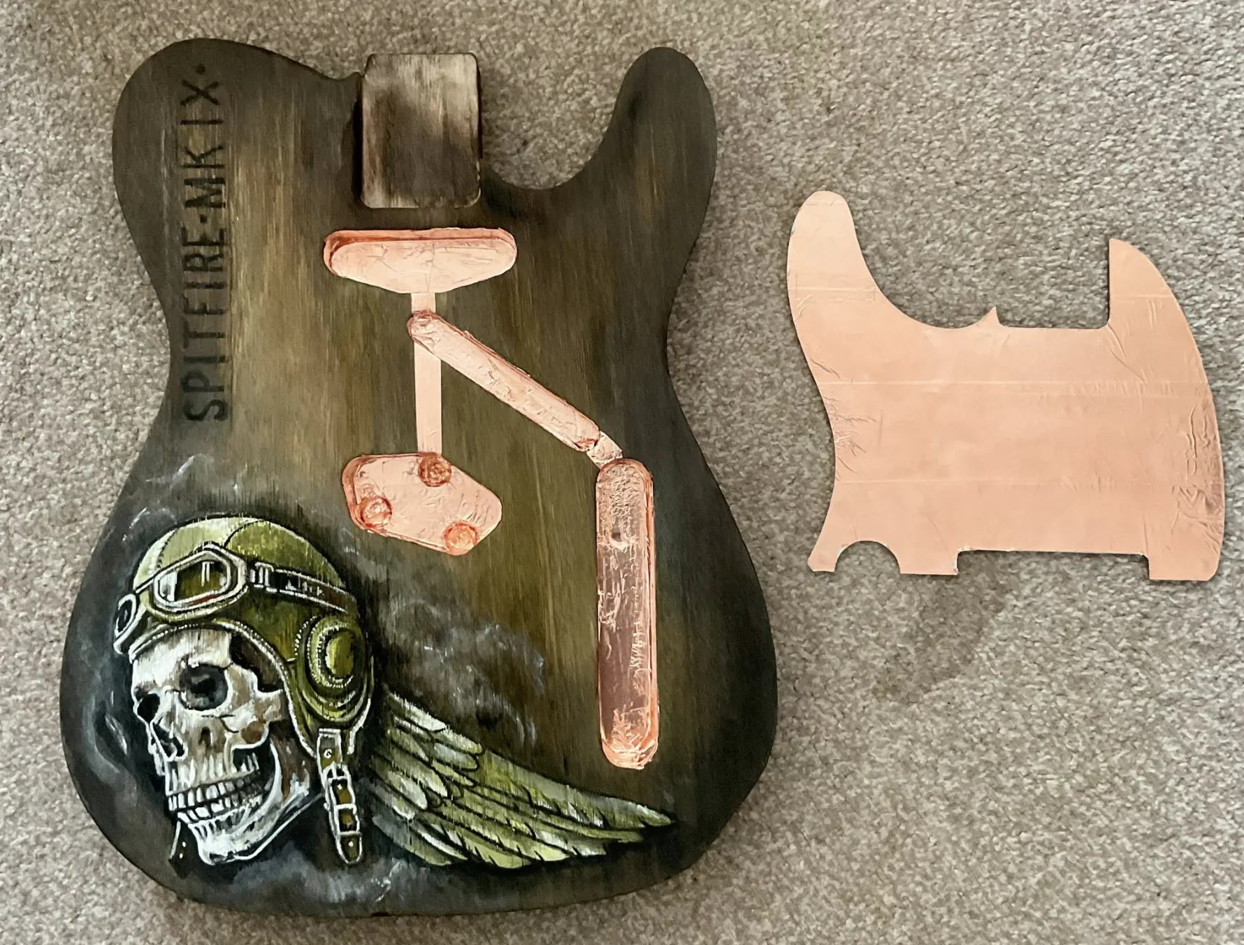 Copper shielding laid into a guitar control cavity beside a copper pickguard